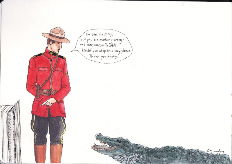 Fraser gesturing to a cage, talking to an alligator